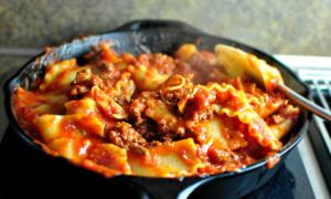 Lazagna with minced meat on a lasagna pan with minced meat in a frying pan